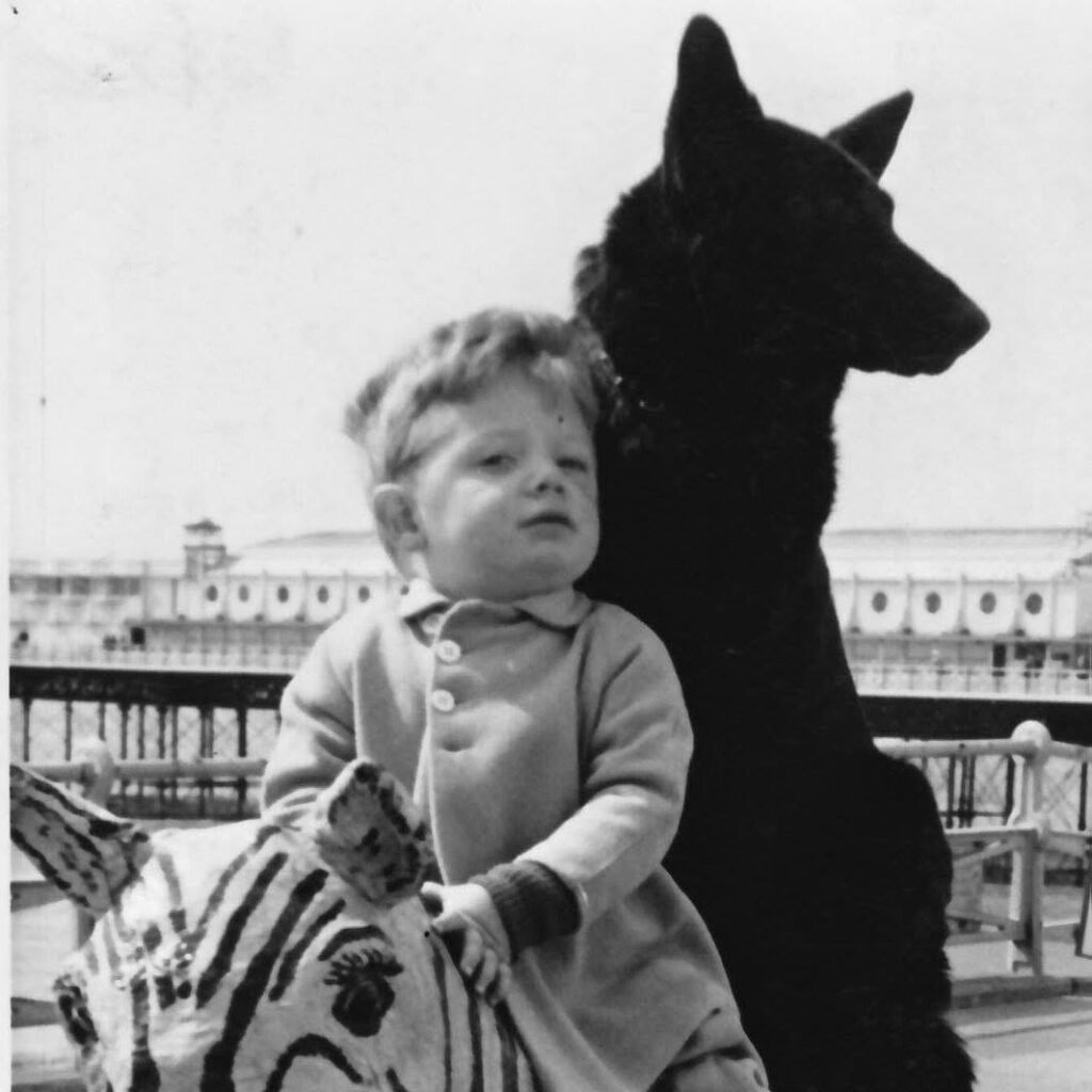 Young Simon Ellinas on Zebra with dog